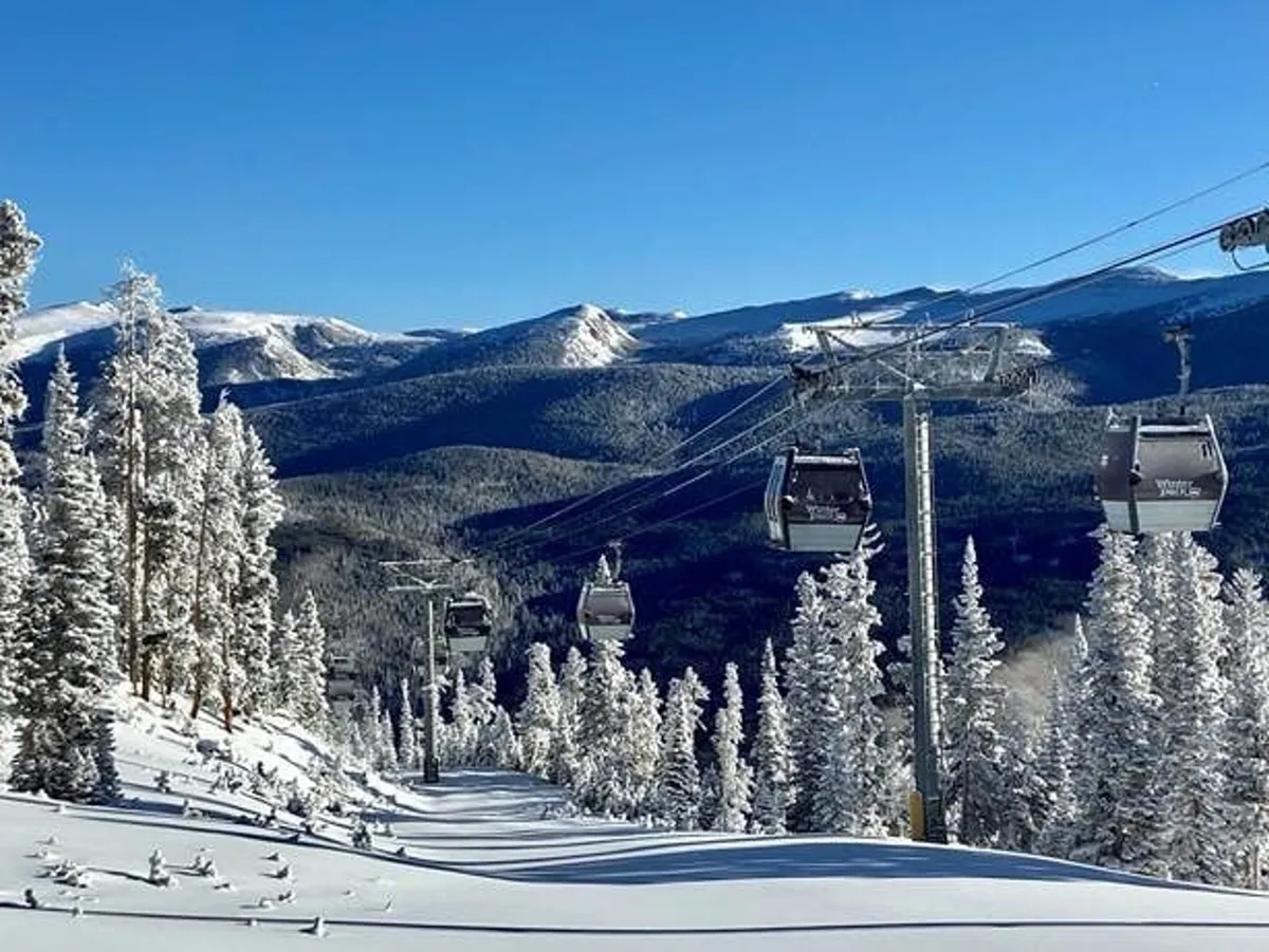 A sweeping exterior view of snow-covered mountain slopes dotted with pine trees, with gondola lifts traversing the landscape and majestic peaks rising in the distance. The scene exudes both adventure and tranquility, capturing the pristine environment and outdoor recreational possibilities.